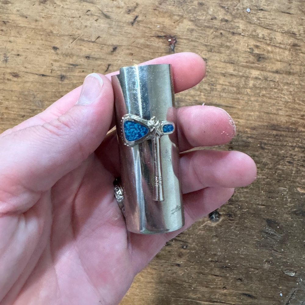 Silver vintage 1970s lighter cover featuring ax detail with turquoise